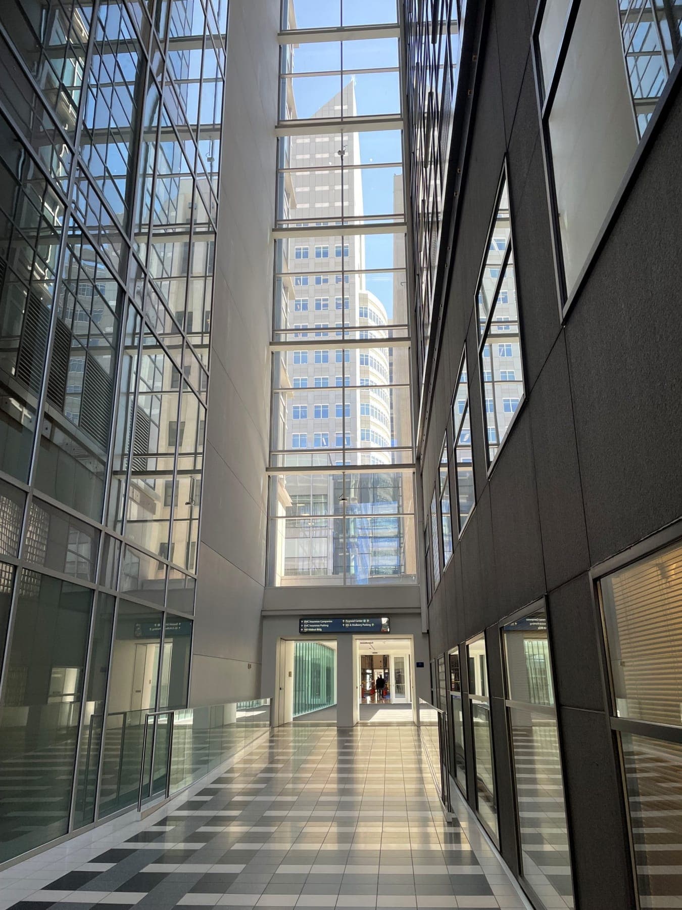 A glass skywalk atrium in downtown Des Moines, flooded with daylight